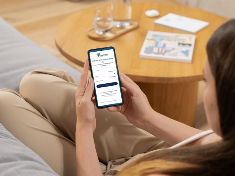 Business owner checking payroll on mobile device