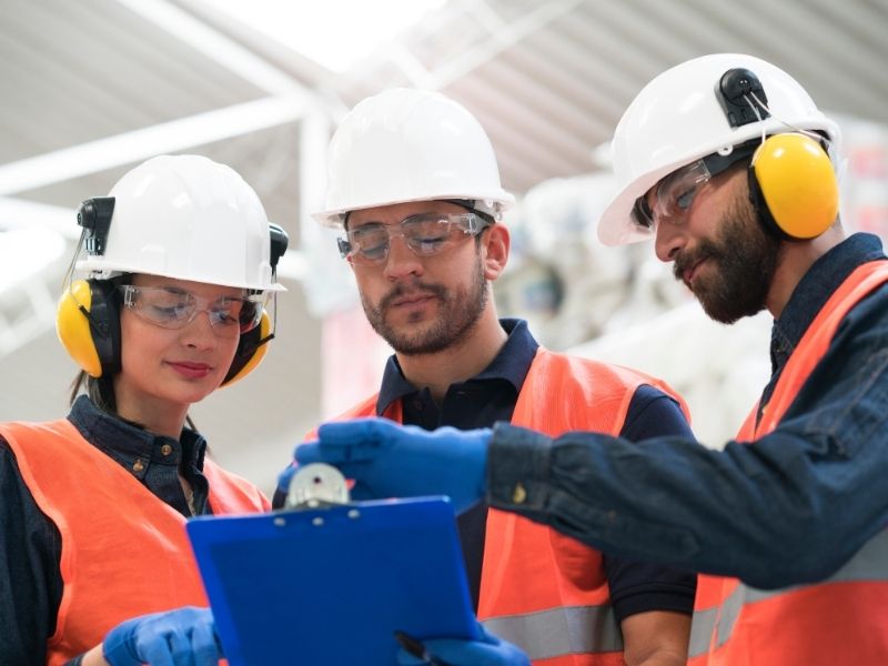 Construction team collaborating with safety equipment