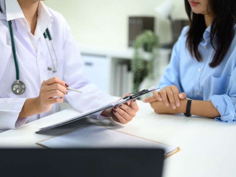 Doctor reviewing patient insurance or medical forms