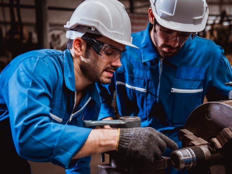 Part-time technician performing equipment repair in a workshop