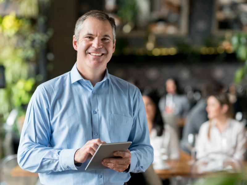 Small business owner standing inside a commercial space protected by property insurance
